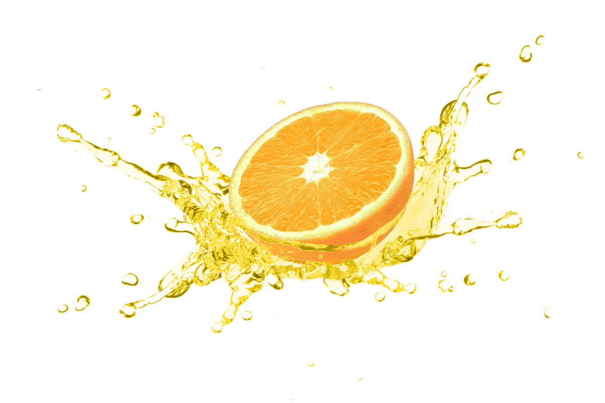 A half orange surrounded by a splash of liquid.