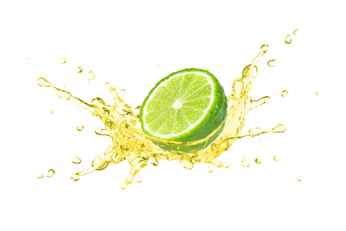 A half lime surrounded by a splash of liquid.